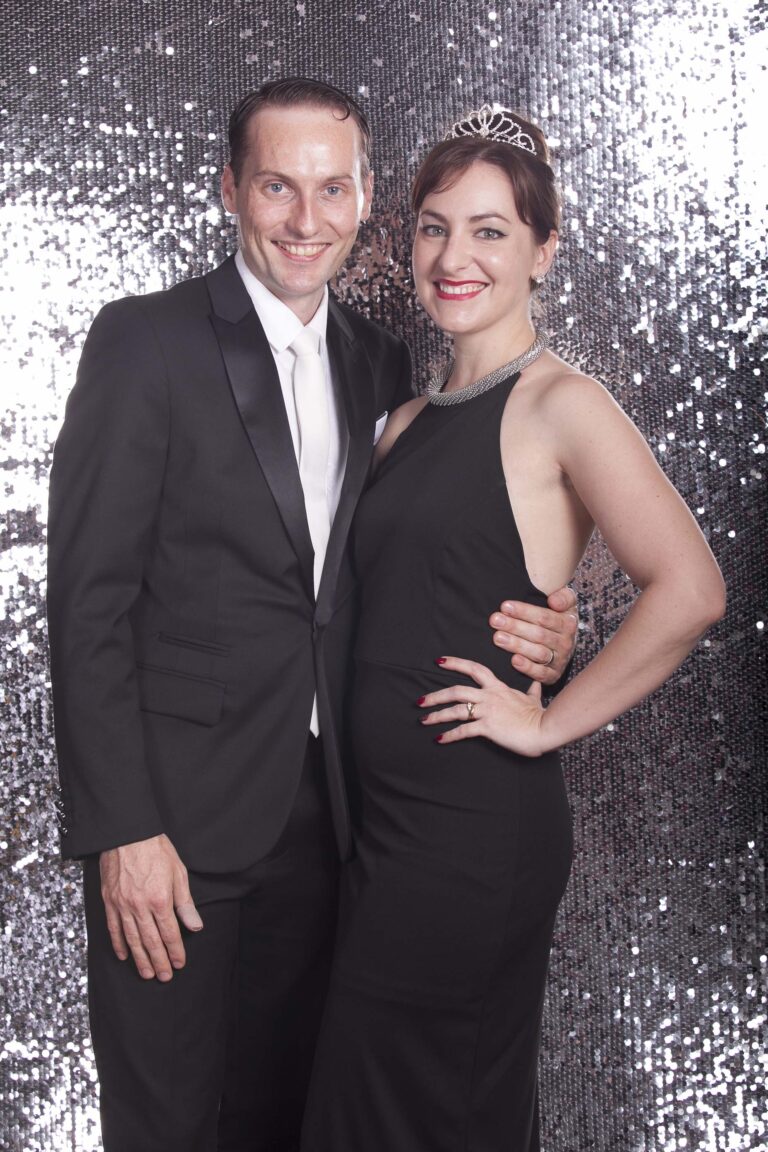 Young couple in front of sequin background